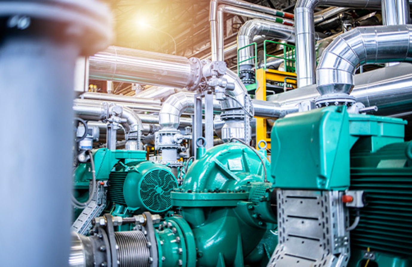 Interior view of an oil and gas petrochemical refinery plant with pipeline and valves.
