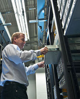 Plant operator working on a control system panel.