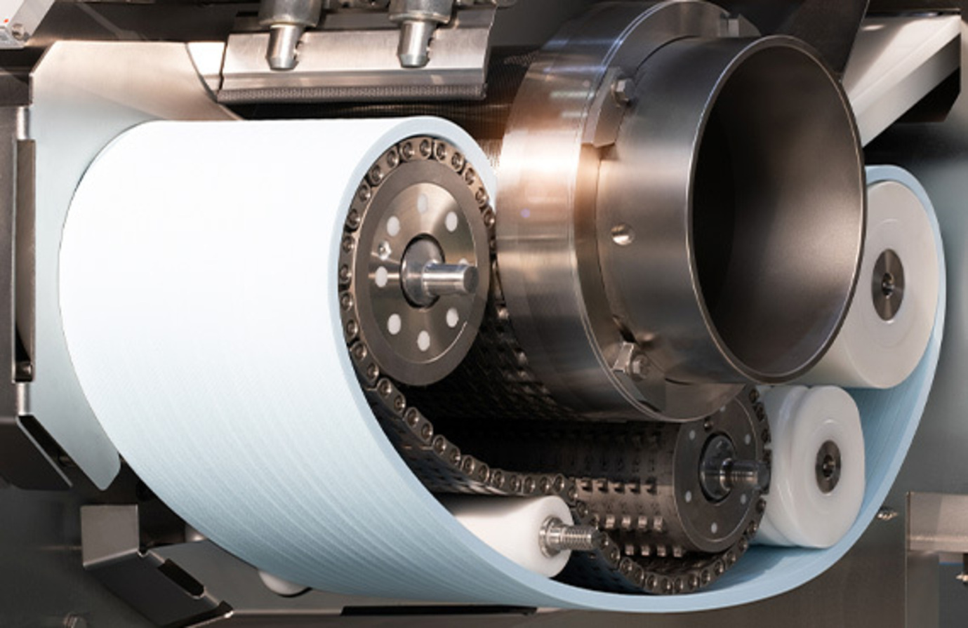 A machine from the pulp and paper industry, showcasing a substantial roll of paper stock for production purposes.