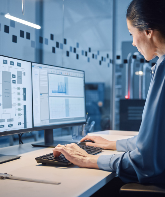 Female control room worker working in front of a computer.