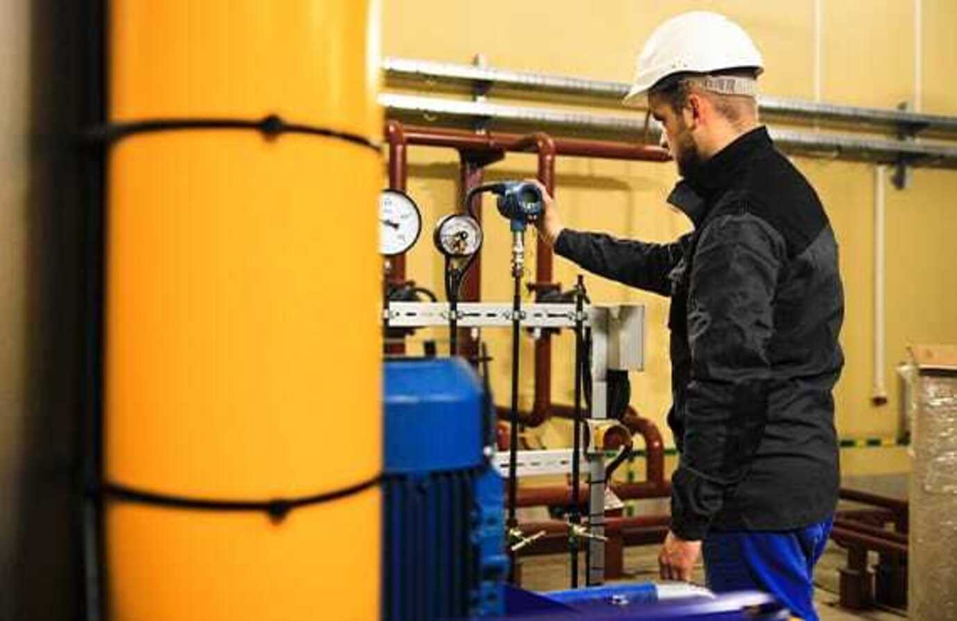 A plant operator checks a sensor for a safety instrumented system (SIS).