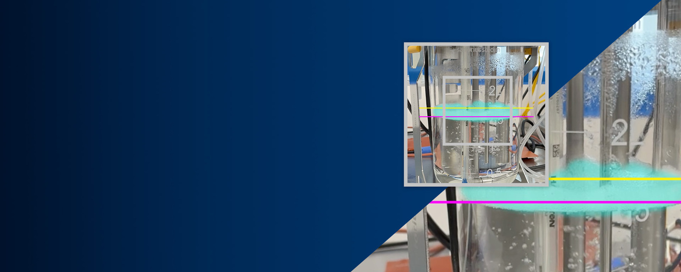 A clear container holding layered clear and light blue liquids with measurement lines overlaid banner