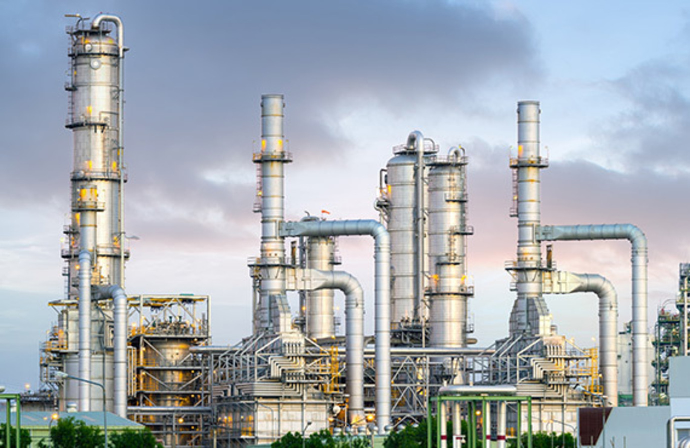 An oil refinery with a complex network of pipes and structures. A hub of activity in the oil industry.
