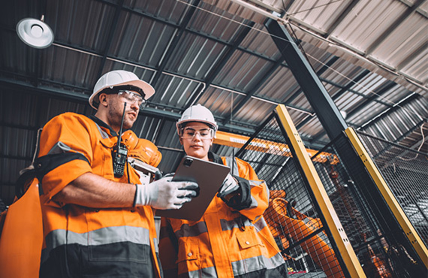 Plant operations: Team members in protective gear operating machinery in a factory, ensuring smooth production.