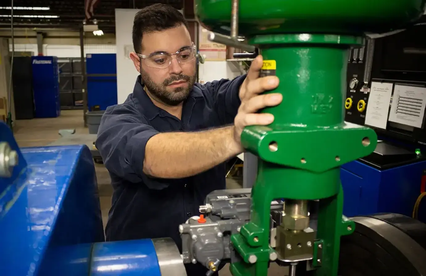 Proconex-employee-working-on-a-green-fisher-control-valve