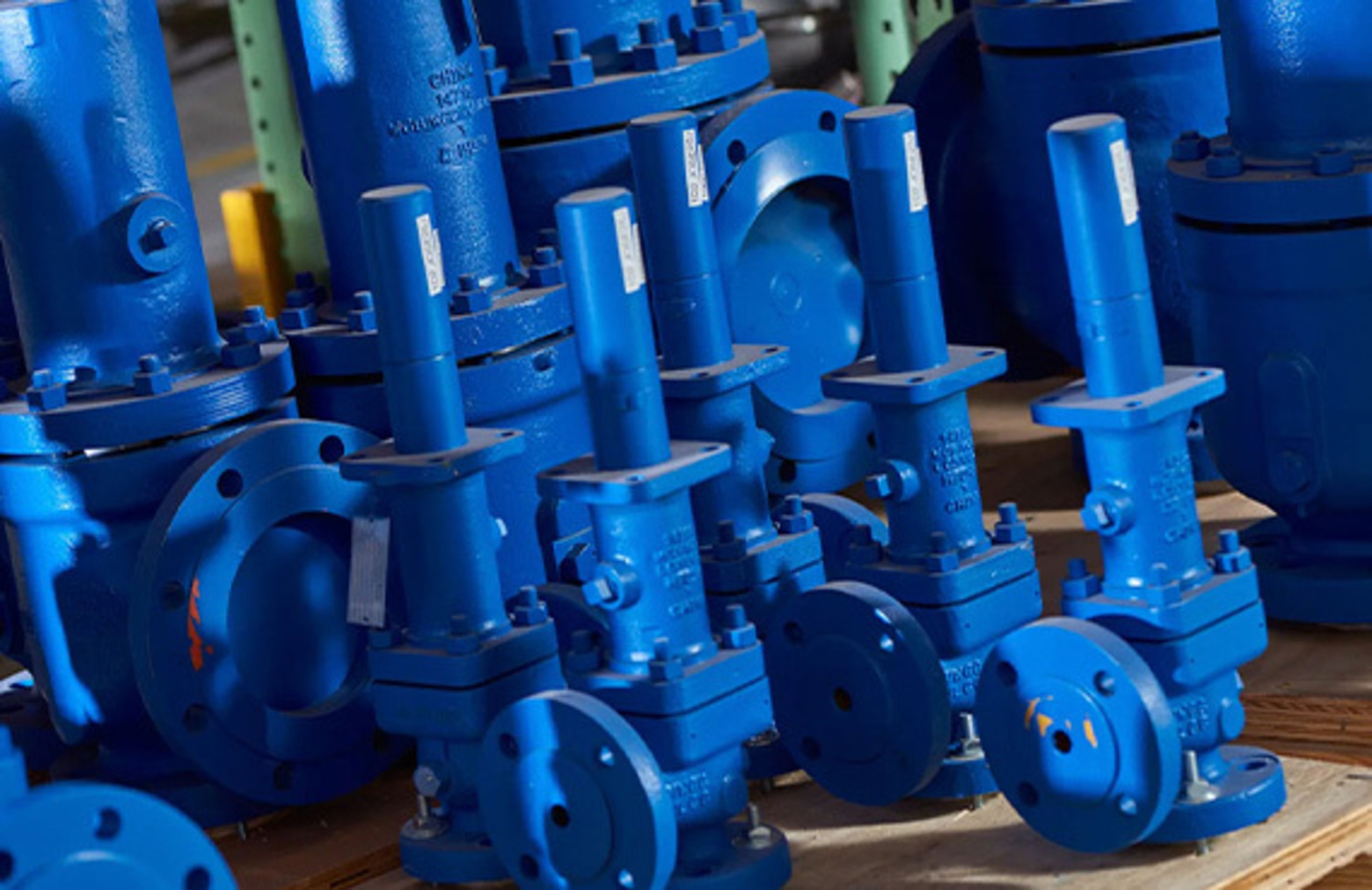A mix of blue Crosby pressure safety valves ready for installation.