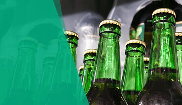 Row of bottles in a factory showing discrete automation processes