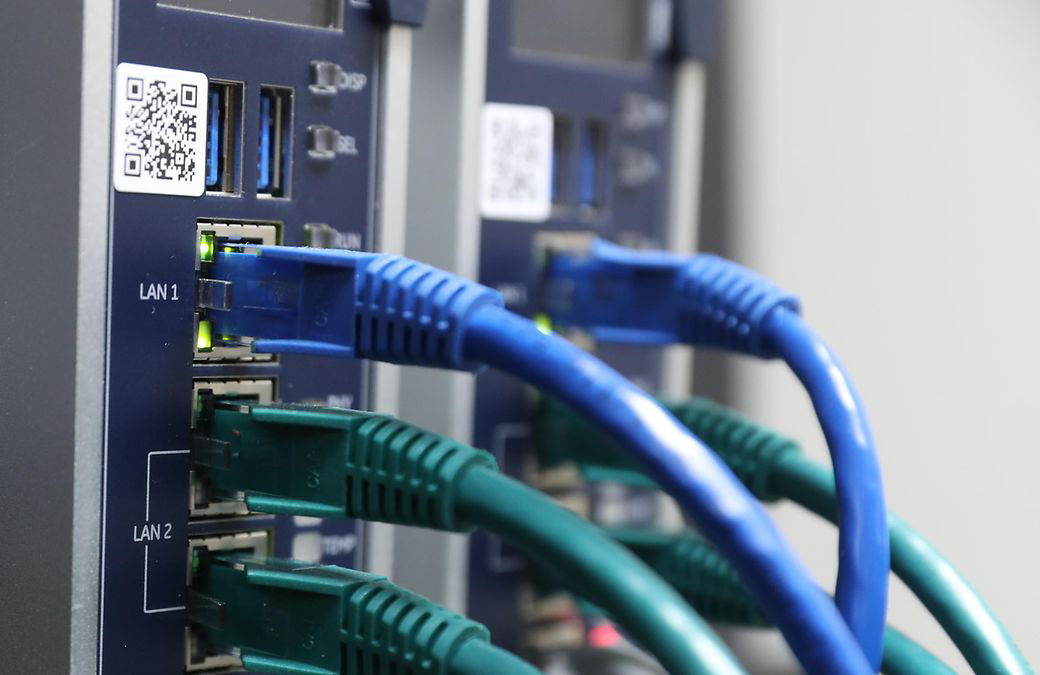 Image shows a close view of an Emerson Electric PLC panel with wires coming out of it