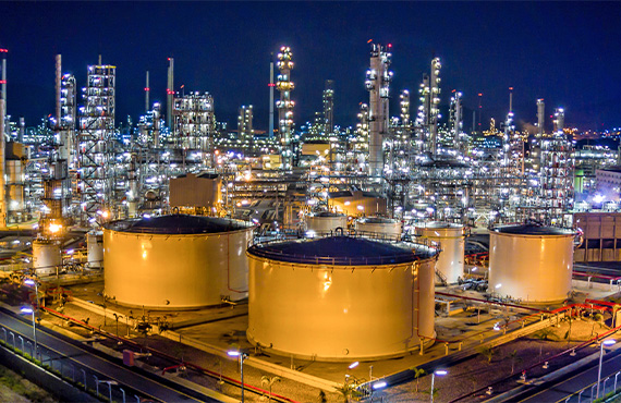 Crude oil refinery at night showing the complexity of the facility.