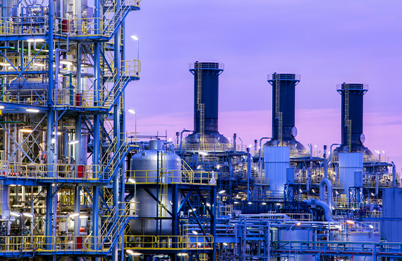 Chemical plant and sunset showing the complexity of the facility and highlighting the need for cybersecurity.
