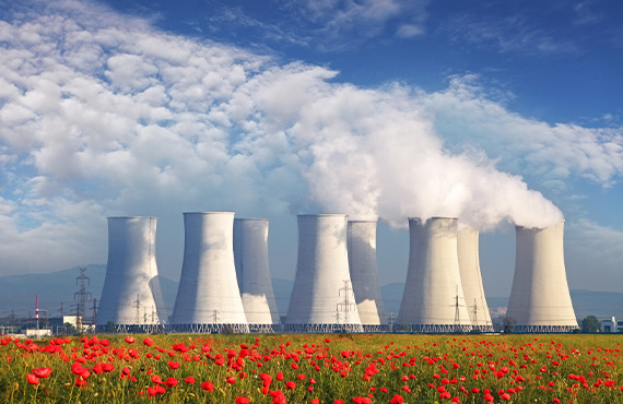 A power plant releases smoke, underscoring the critical need for robust cybersecurity in steam energy production.