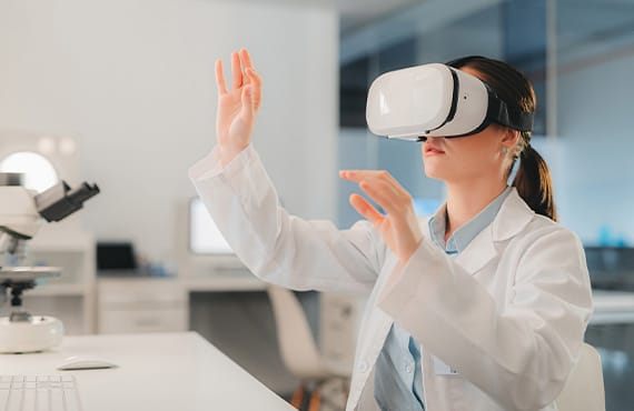 Female scientist in a lab wearing VR glasses, exploring digital transformation in life sciences operations.