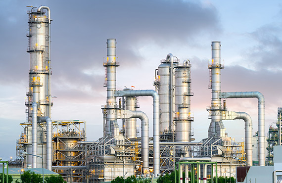 An oil refinery with a complex network of pipes and structures. A hub of activity in the oil industry.