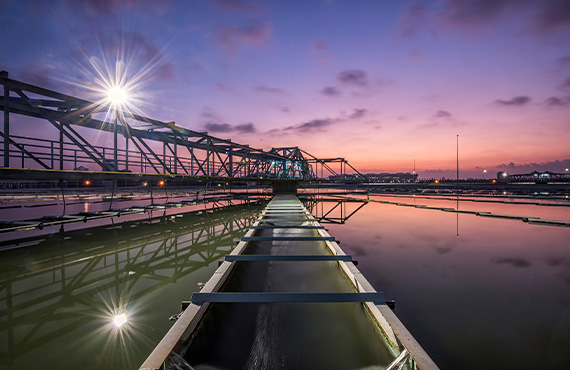 A water treatment plant at sunset with real-time water quality monitoring systems.