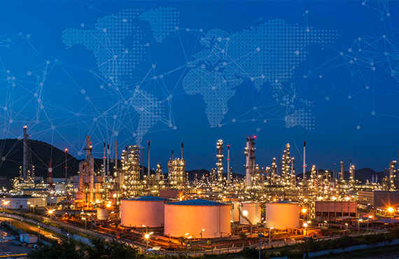 OT cybersecurity network graphic over an oil refinery at dusk.