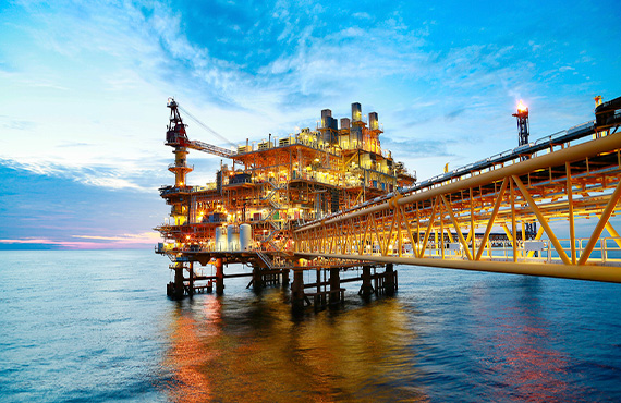 A serene dusk view of an oil rig in the ocean, highlighting the importance of safety in offshore oil and gas platforms.