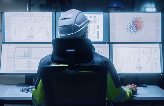 A worker holding managing facilities in a control room. Cyber Risks in industrial control systems.