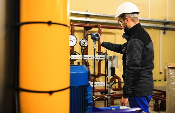 A plant operator checks a sensor for a safety instrumented system (SIS).