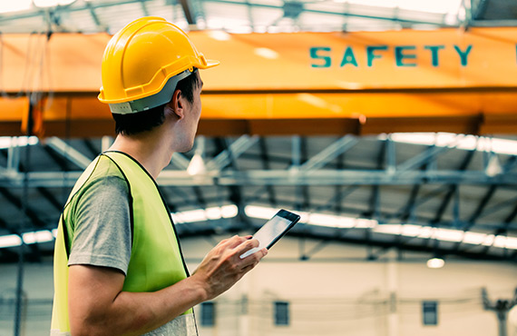 A team member in a factory checking performing quality control.