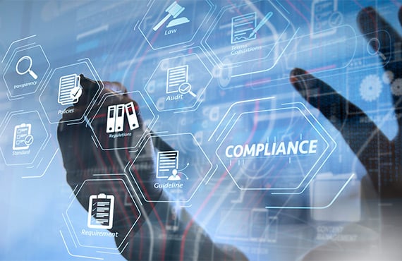 A businessperson interacts with a digital screen displaying business icons, emphasizing regulatory compliance.