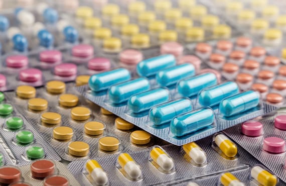 Pills in blister packs manufactured using batch processing.
