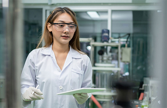 Image displays a laboratory technician using an ipad with a safety instrumented system.