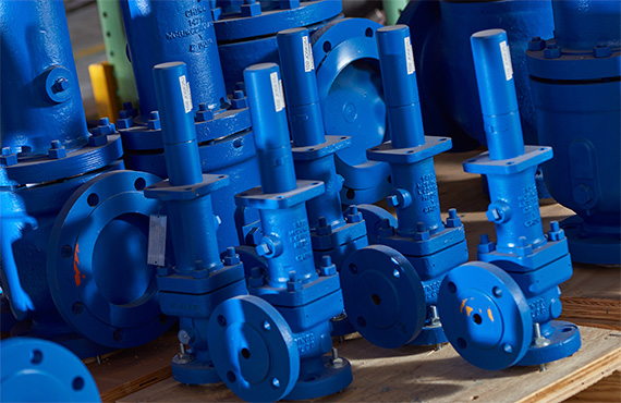 Variety of blue Crosby Pressure Relief Valves sitting on a pallet
