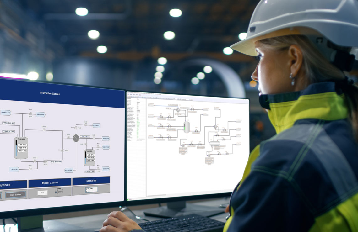 Industrial engineer with a hardhat using Emerson DeltaV software