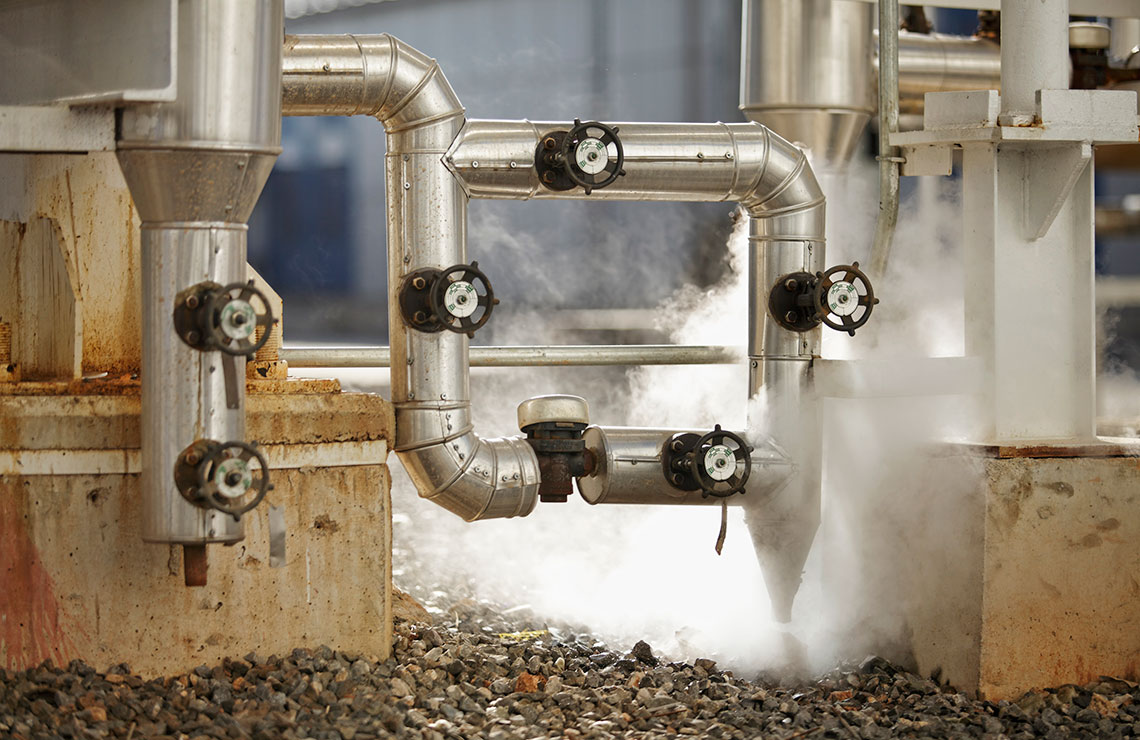 Pipelines releasing steam pressure at industrial facility