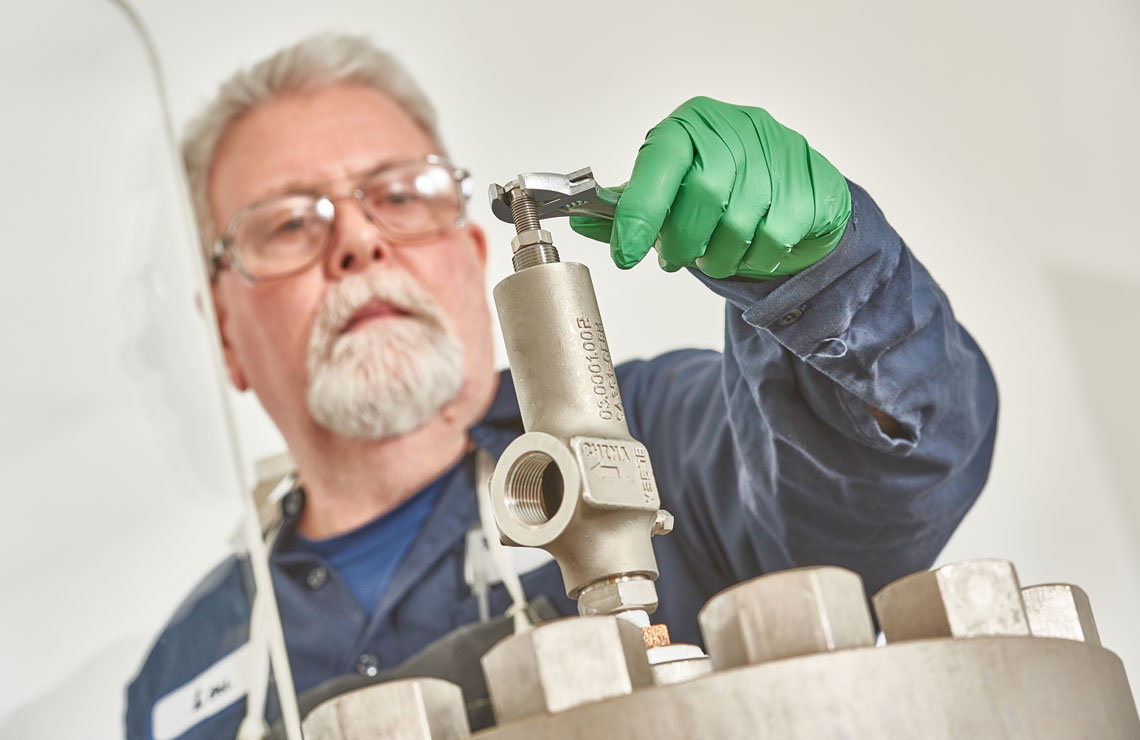 Valve technician using a wrench to tighten a pressure relief valve